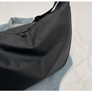 Close-up of black matte waterproof nylon dumpling bag with premium metal zippers