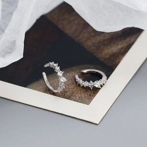 Macro detail of S925 sterling silver ear cuffs with sparkling zircon stone settings