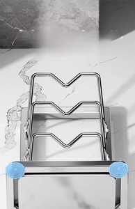Detail of non-slip suction cups on a stainless steel kitchen pot lid and board organizer
