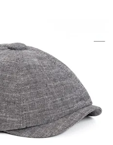 Macro shot of grey newsboy hat featuring a flexible foldable brim and textured fabric