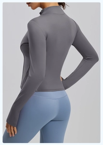 Close-up of slim-fit yoga jacket with stand collar and ergonomic grey stitching details