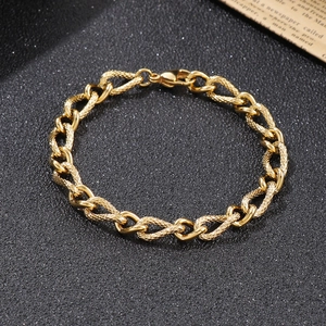 Close-up of 7mm golden snake link chain with lobster clasp on a dark textured surface