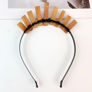 Close-up of handmade natural crystal crown with orange stones and black metal wire