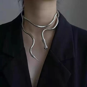 Detail of silver snake-shaped necklace on model in Y2K punk gothic aesthetic style