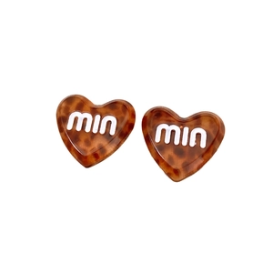 Fashionable acetate heart earrings with tortoiseshell pattern and embossed logo design