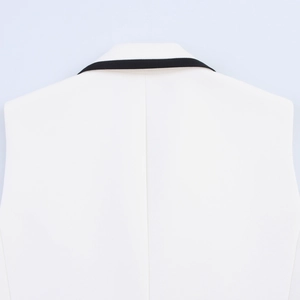 Detailed view of white vest back featuring black contrast collar trim and vertical seam