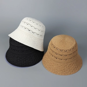 Close-up of hollow knitted bucket hats in white, black, and khaki showing breathable texture