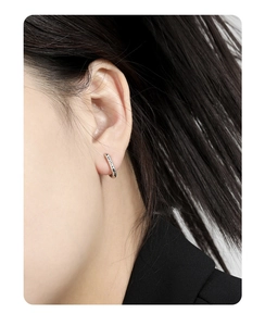 Detailed close-up of S925 silver U-shaped earrings with irregular lava texture on model