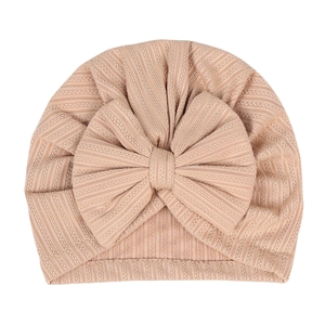 Elastic ribbed newborn baby hat with large bow decoration in cinnamon pink color