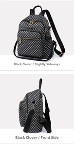 Detail view of the black four-leaf clover print backpack with gold metal hardware