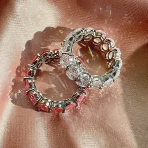 Detailed close-up of S925 silver eternity rings with pink and white oval-cut crystals