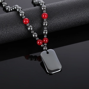 Beaded hematite necklace with red agate accents and a sleek rectangular stone pendant