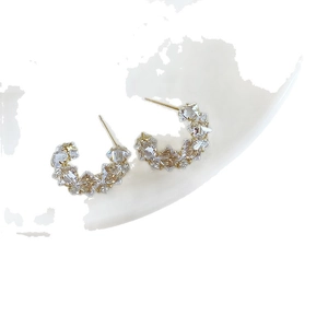 Sparkling gold C-shaped earrings with clear crystals for a stylish luxury design