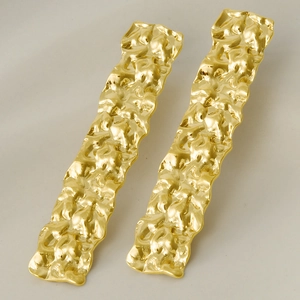 Detail view of 304 stainless steel earrings with hammered texture and golden finish