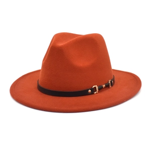Close-up of caramel wool fedora hat featuring a black leather band and gold metal buckle
