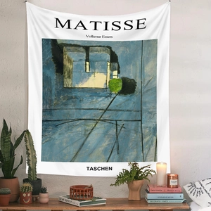 Close-up of Matisse art tapestry hanging on white wall with boho home decor accents