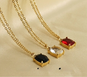 Macro detail of 18K gold plated stainless steel necklaces with rectangular zircon pendants