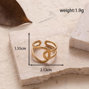 Adjustable gold stainless steel heart hollow ring displayed on minimalist textured stone