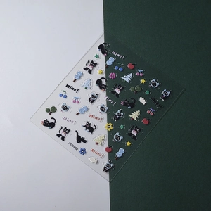 Detail of 5D embossed nail art stickers featuring cute black cats, stars, and cherries