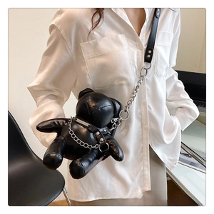 Detail of cute black PU leather bear crossbody bag with silver punk chain and rivets