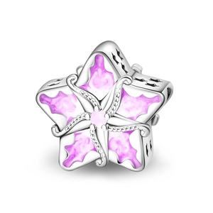 Silver star charm bead with purple enamel inlay and pink zircon on a white background