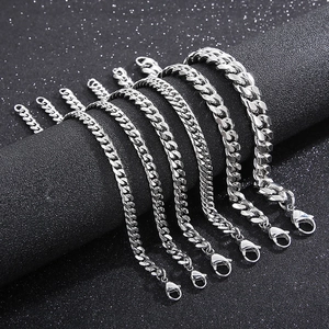 Polished stainless steel Cuban link bracelets in various sizes on black display stand