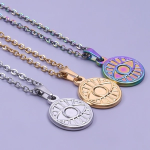 Three evil eye oval pendant necklaces in silver, gold, and rainbow stainless steel