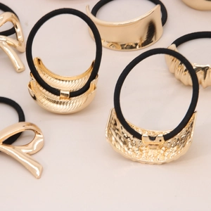 Elastic hair ties set with premium gold metal bow and geometric shapes in black color