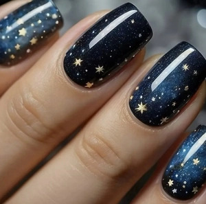 Macro detail of deep blue galaxy square press-on nails with gold stars and shimmer