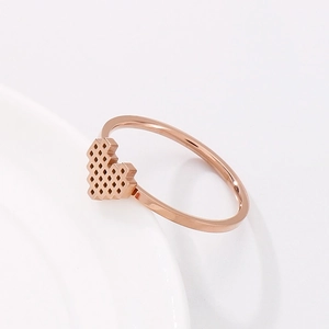 Elegant rose gold honeycomb heart ring with diamond accents in minimalist steel