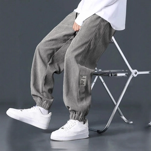 Men's grey corduroy cargo pants in a relaxed fit with side pocket and ribbed texture