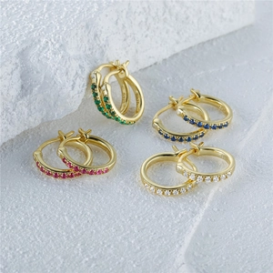 Macro detail of S925 sterling silver hoop earrings set with colorful zircon stones