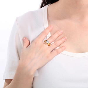 Close-up of a 6mm 18K gold plated stainless steel ring with a clear solitaire zircon