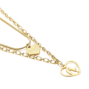 Gold double-layered necklace featuring a heart pendant and couple kissing silhouette charm
