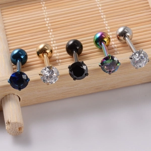Detailed close-up of 5 colorful zircon tongue rings with metallic finish on a bamboo stand