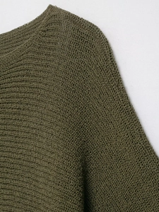 Detailed macro view of olive green knit fabric texture and crew neck stitching detail
