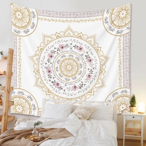 Detail of bohemian mandala tapestry with pink roses and gold patterns on a white wall