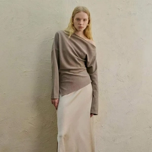 Coffee brown off-shoulder knit long sleeve top paired with a cream satin skirt