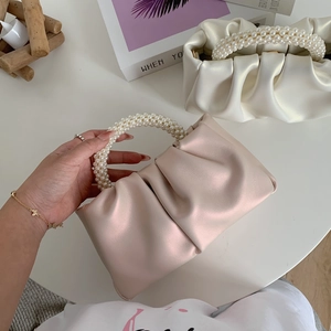 Detailed view of cloud bag with pearl handle and pleated PU leather texture