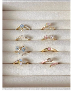 Detailed macro view of S925 silver rings with floral and pearl elements in display box