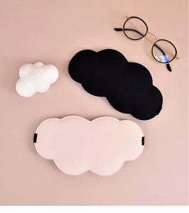 Flat lay of pink and black cloud-shaped sleep masks with soft ice silk texture