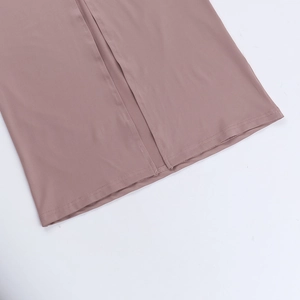 Detailed close-up of the elegant side slit and refined stitching on a dusty rose dress