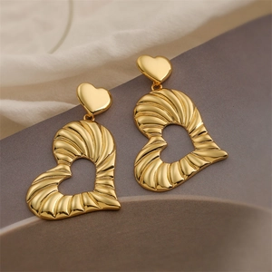 Detailed view of 18K gold plated heart earrings with unique wrinkled metal texture