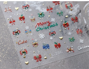 Macro detail of 3D embossed Christmas nail stickers with snowflakes and bows TL-286