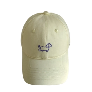Creamy beige cotton baseball cap featuring purple puppy embroidery on a minimalist design
