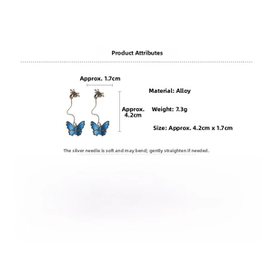 Detailed view of vintage blue enamel butterfly earrings with silver needles and alloy