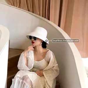 Detail of white woven straw sun hat with textured brim for elegant vacation styling