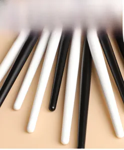 Ergonomic tapered wood makeup brush handles in black and white finish detail