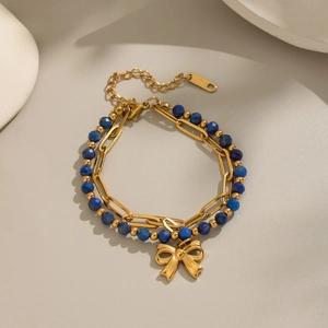 Close-up of double-layer lapis lazuli beaded bracelet with gold bowknot pendant