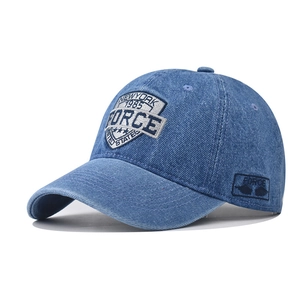 Macro shot of detailed 1985 FORCE embroidery on high-quality washed navy denim baseball cap